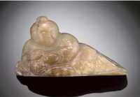 Ming Dynasty A celadon and russet jade model of a boy